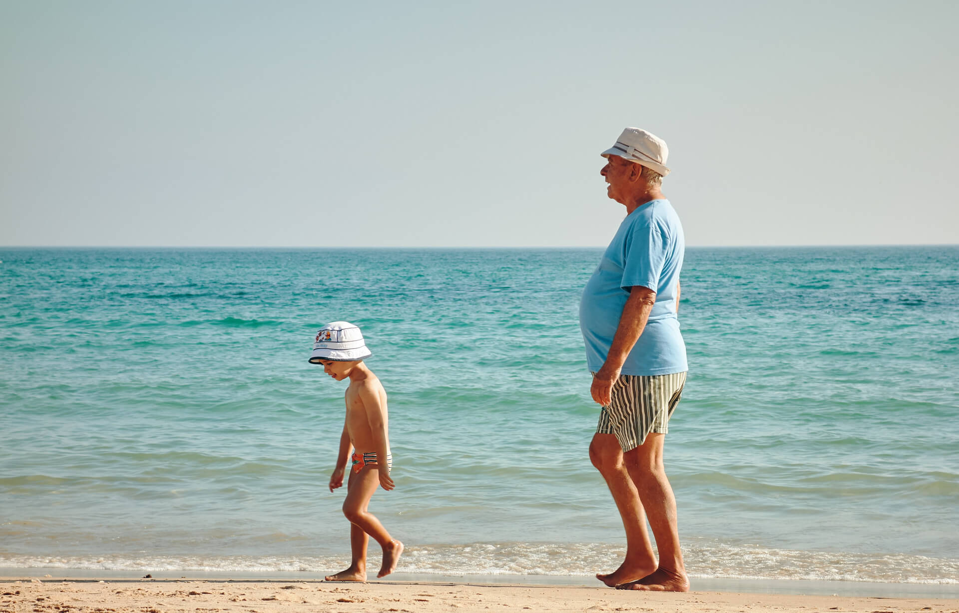 A person standing on a beach

            Description automatically generated